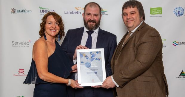 Fran Leddra and Mark Harvey accept an outstanding achievement award on Lyn Romeo's behalf.