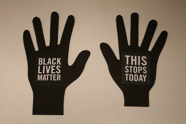 Black lives matter written on outstretched palms