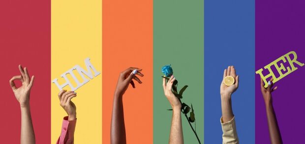 Arms of different genders and skin tones against a rainbow backdrop