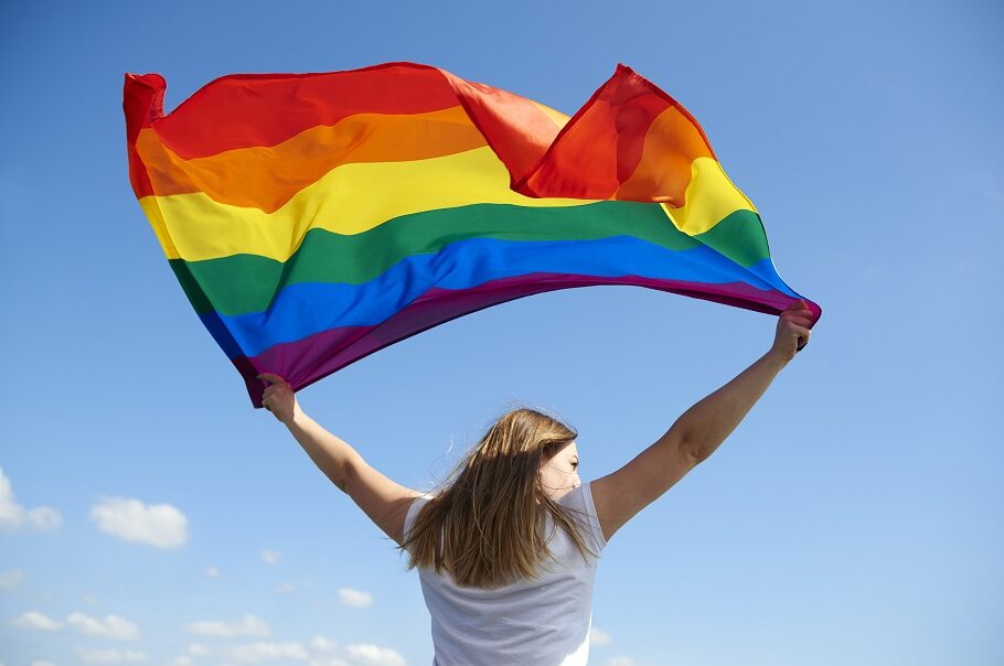 Woman holding rainbow flag