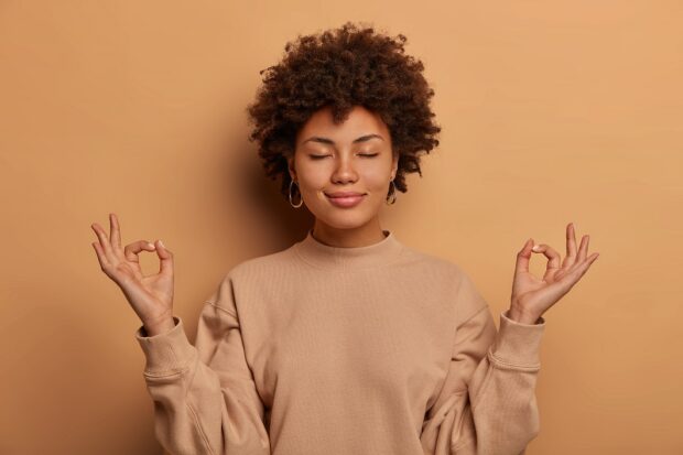 A black woman practicing yoga