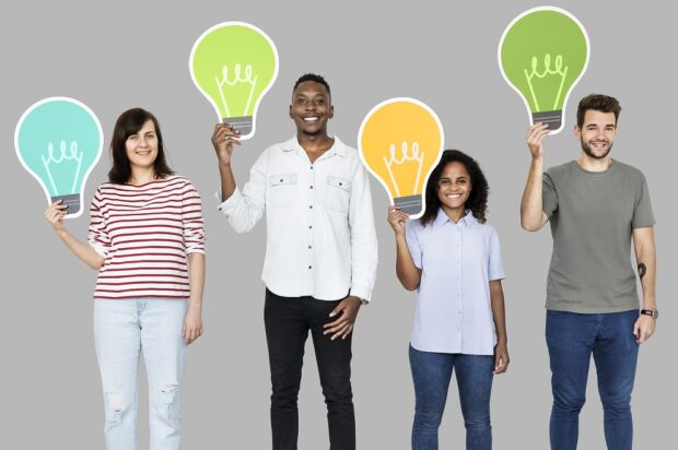 Diverse group holding lightbulb icons