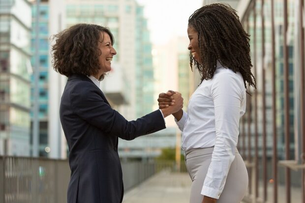 Two women celebrate team work