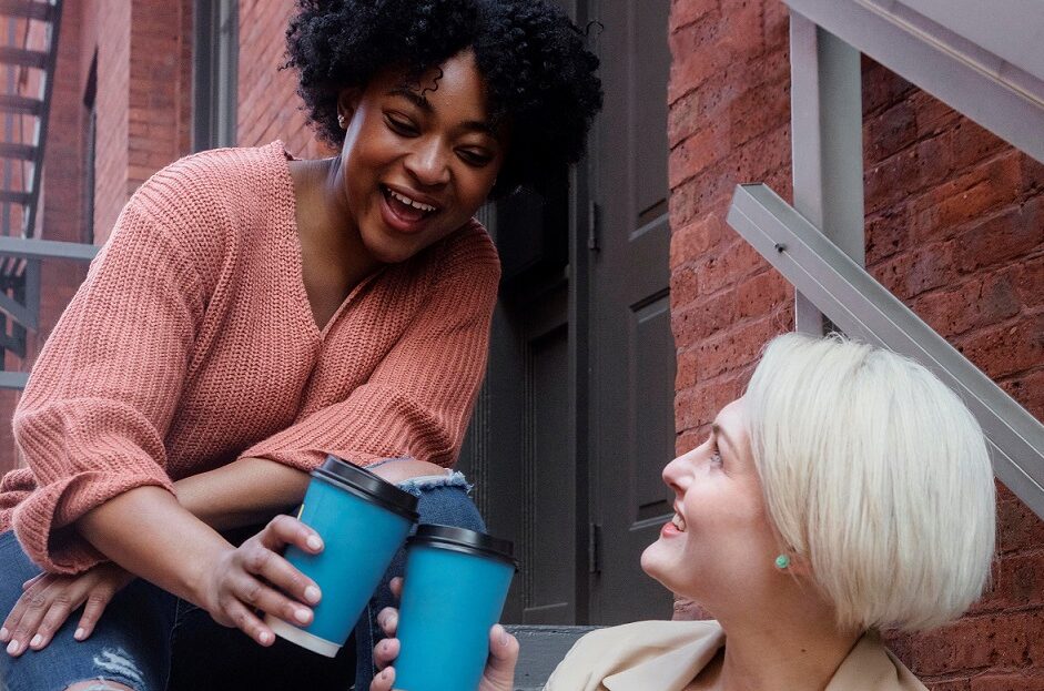 Two carers enjoying some down time with a coffee